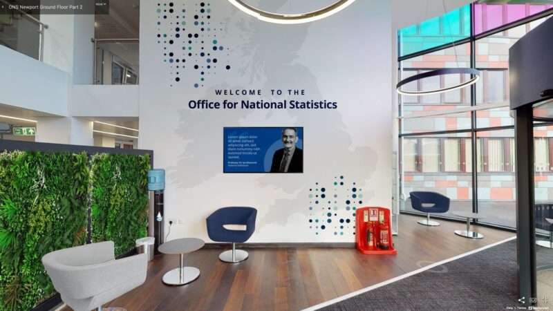 Photograph of a wall in the ONS reception area showing a rendered concept the 'dots' applied to the wall above and .beneath a welcome message above a quote with picture from Sir Ian Diamond.